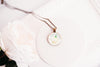Honeysuckle birth flower necklace close-up detail – glass cabochon pendant with honeysuckle illustration