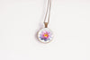 Water lily birth flower pendant close-up on bronze-plated chain – July birth flower glass cabochon