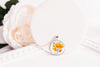Necklace with a floral California poppies image pendant on a white background