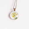 February birth flower necklace featuring yellow primrose in a bronze-plated setting - Whimsy Spirit Shop