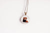 Necklace with a pendant featuring a red panda wearing a flower crown on a white background