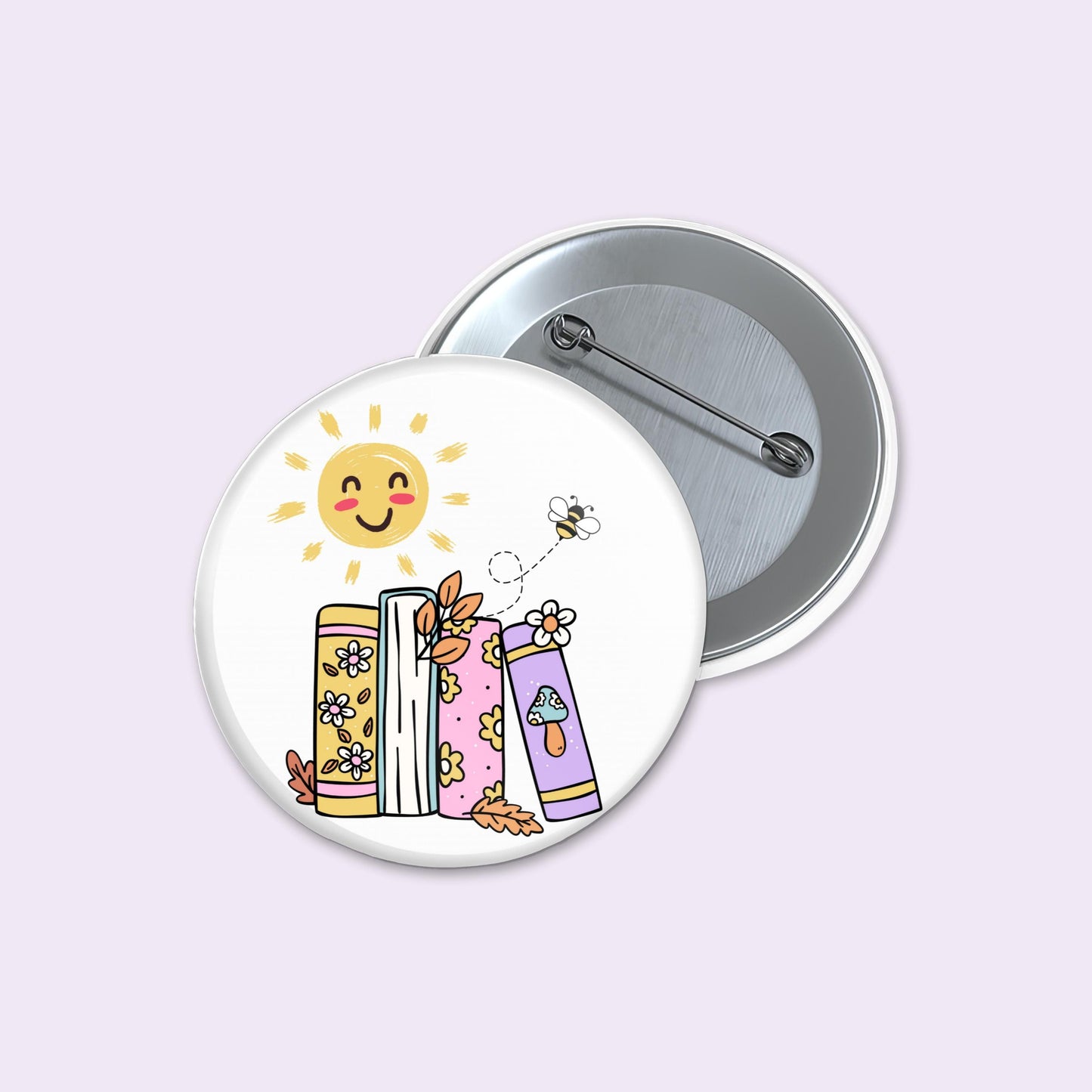 Button badge with a sun, books, and bee illustration on a light purple background