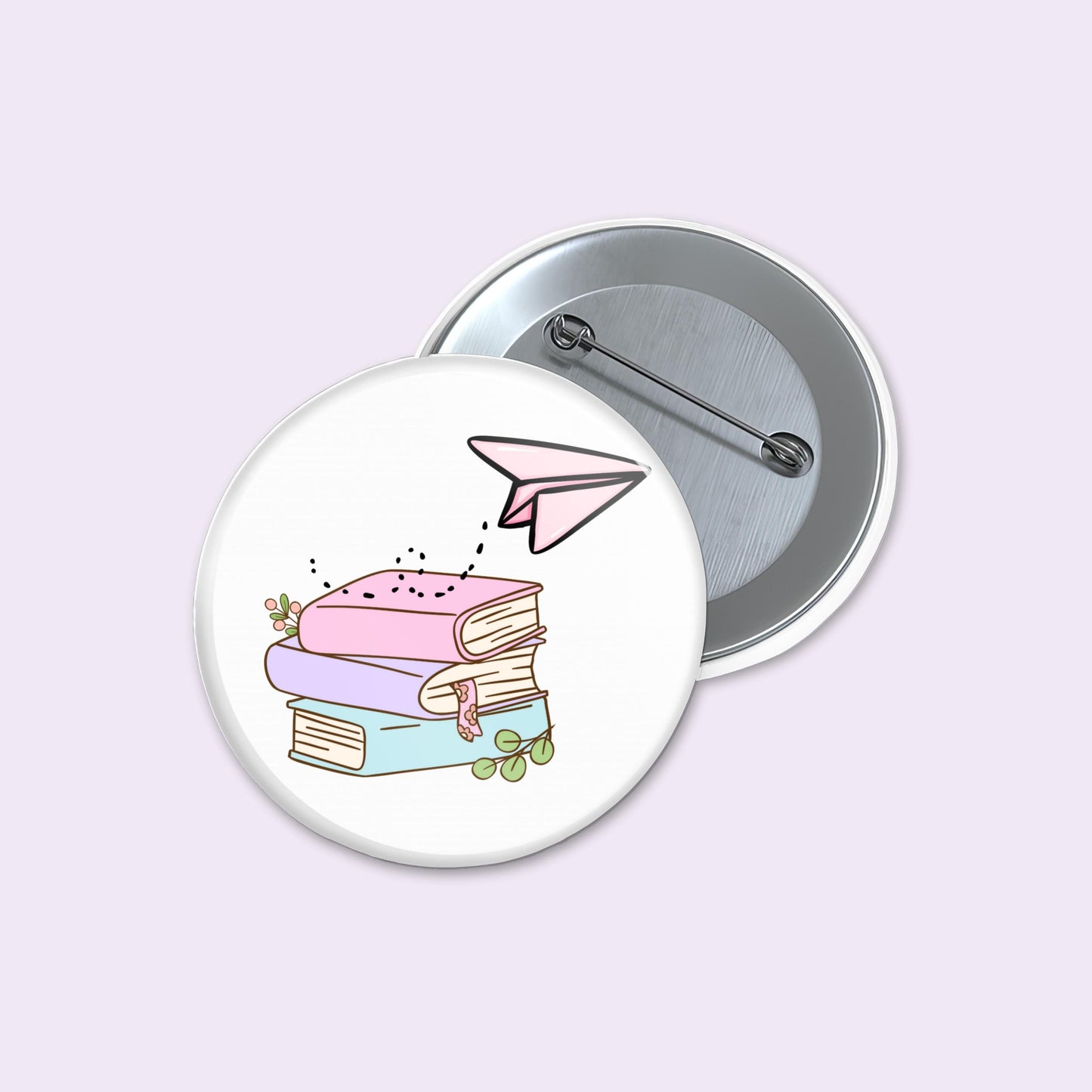 Button badge with illustration of books and a paper airplane on a light purple background