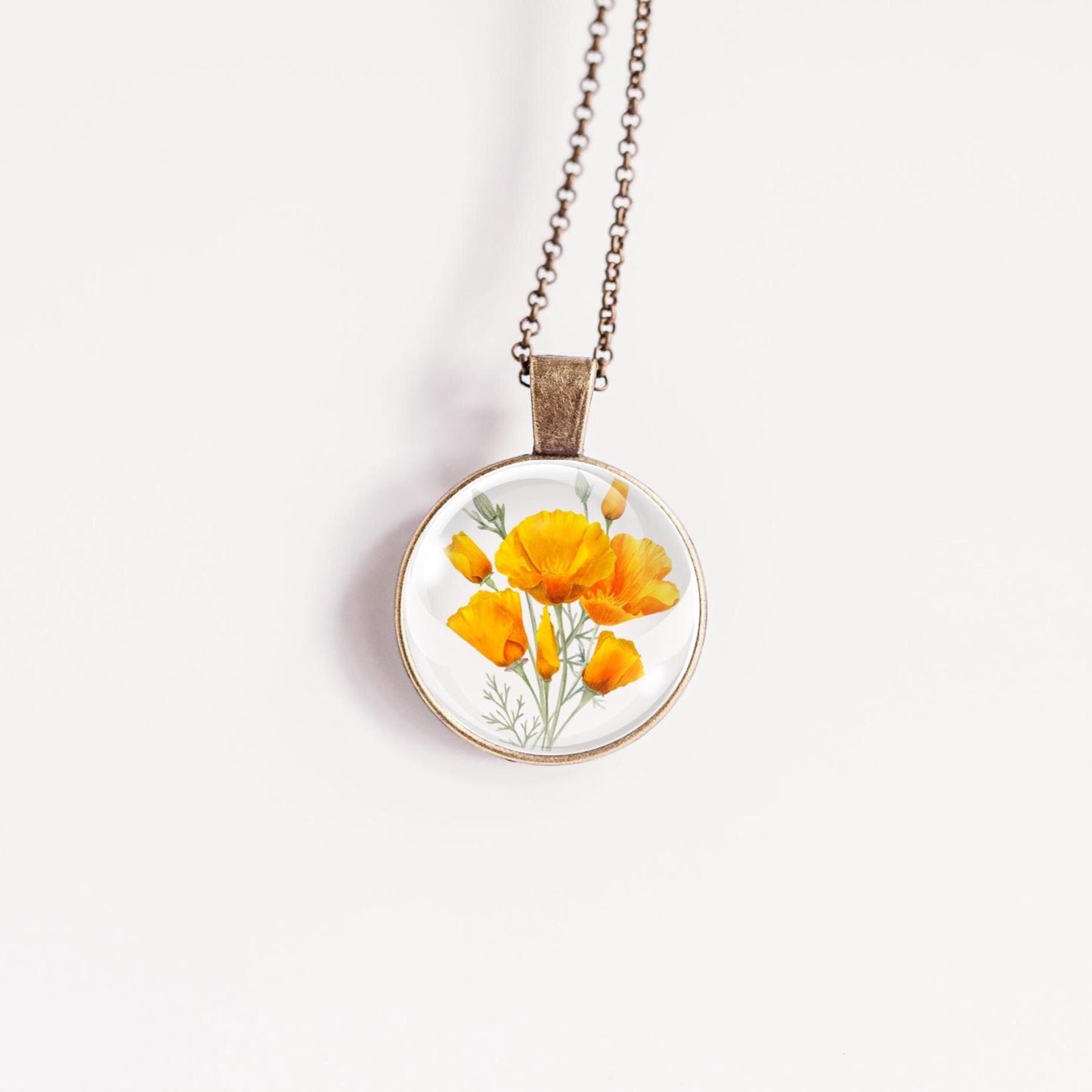 Necklace with a floral California poppies image pendant on a white background