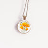 Necklace with a floral California poppies image pendant on a white background