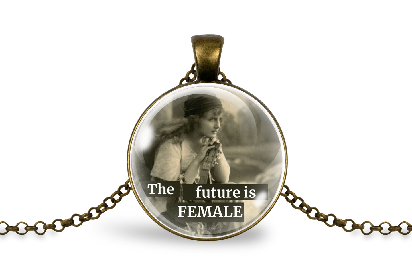 A round pendant necklace with an antique bronze-colored metal frame and chain, featuring a sepia-toned vintage photograph of a woman and the text 'The future is FEMALE' printed across the bottom.