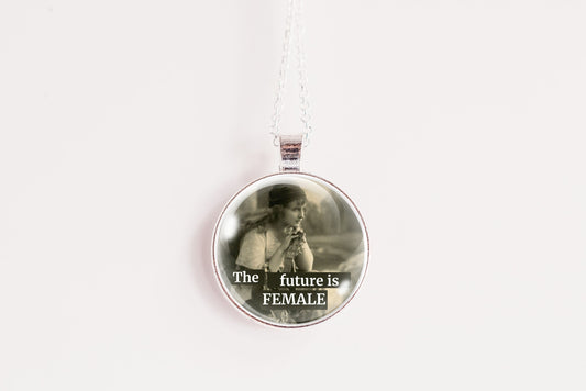 Product photo of a 1-inch glass cabochon pendant necklace featuring “The Future Is Female” with a soft sepia side-profile portrait of a vintage woman on a 20-inch chain.