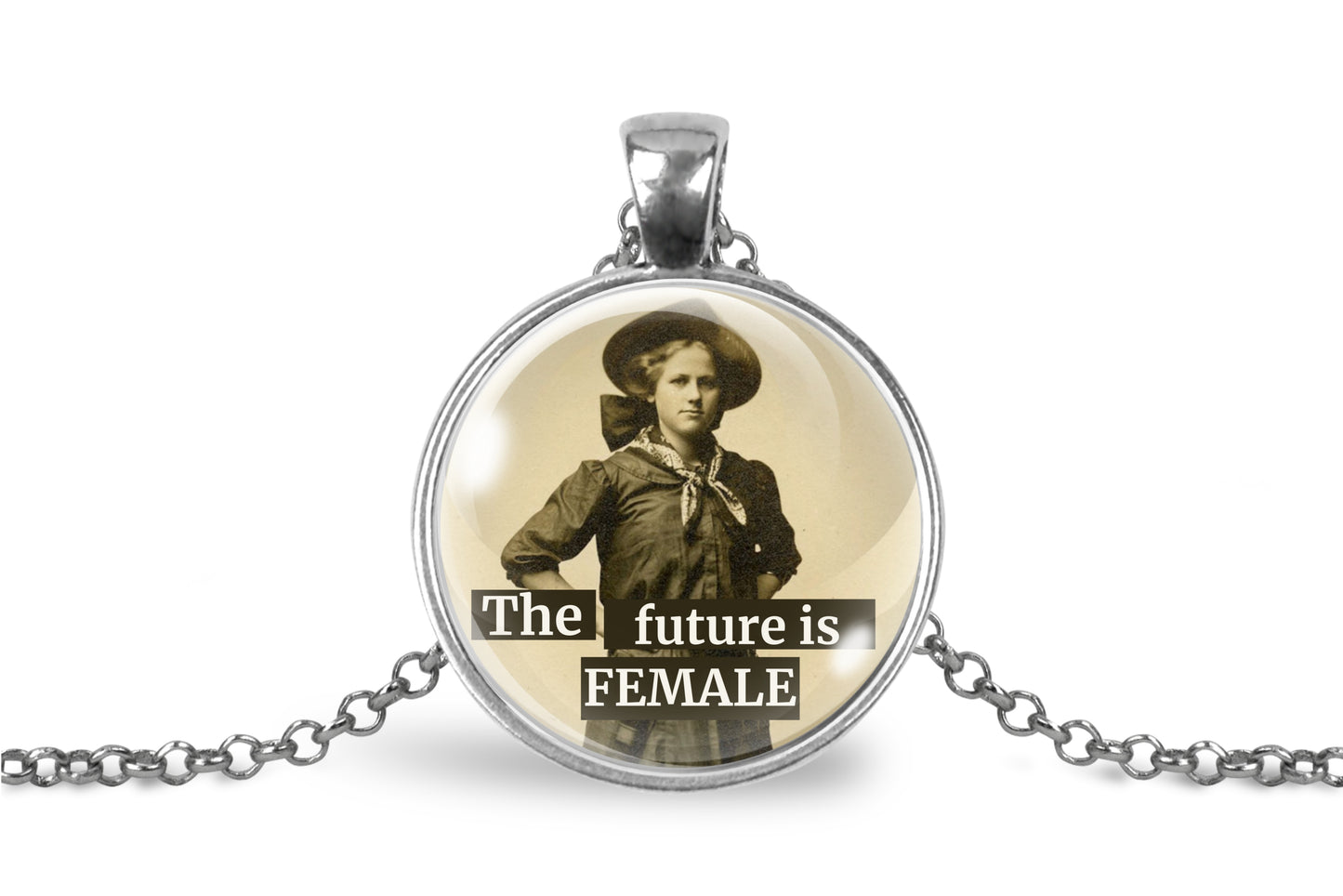 A silver pendant necklace featuring a vintage-style circular photo of a woman in a cowboy hat with the text 'The future is FEMALE' printed over the image, shown on a white background.