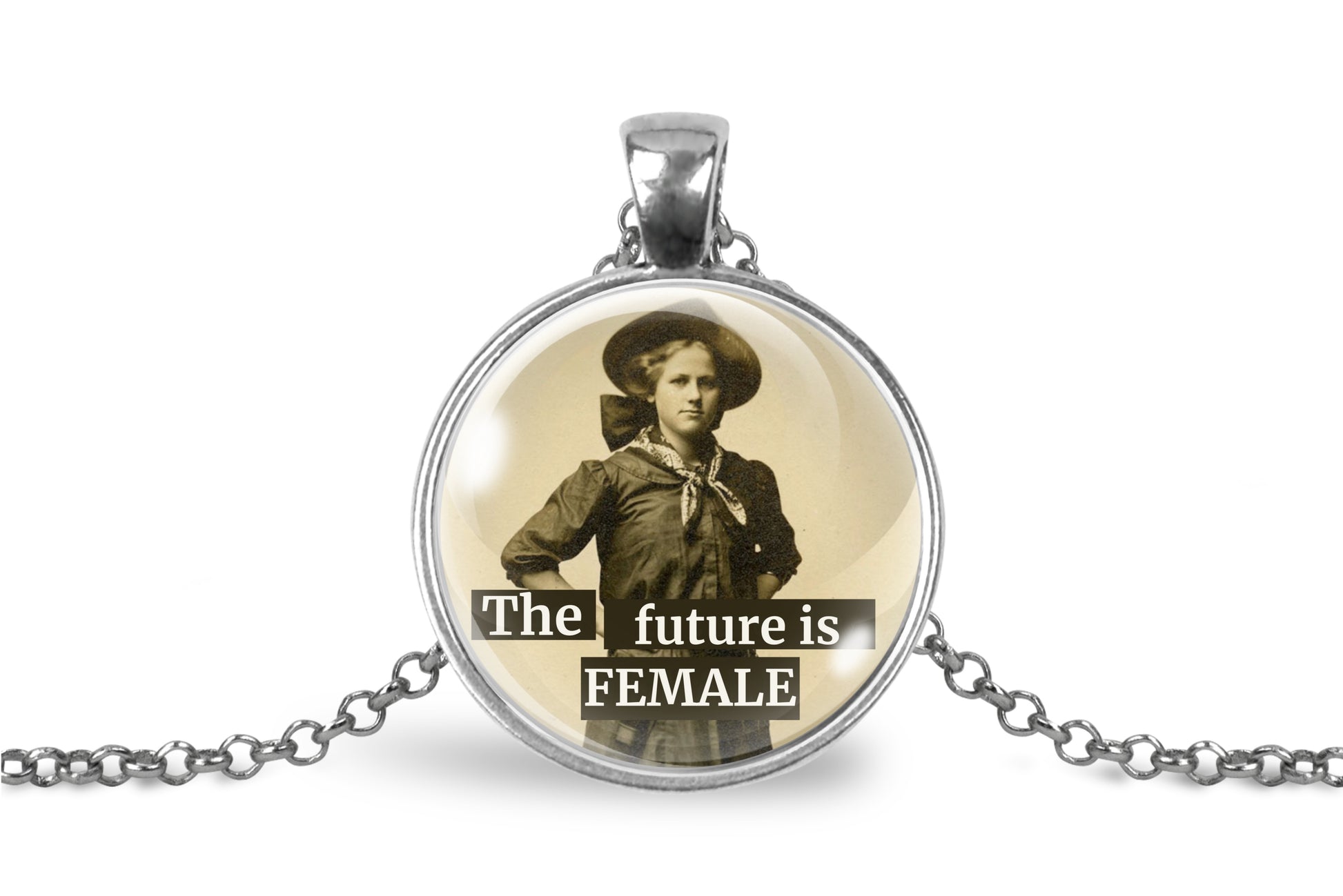 A silver pendant necklace featuring a vintage-style circular photo of a woman in a cowboy hat with the text 'The future is FEMALE' printed over the image, shown on a white background.