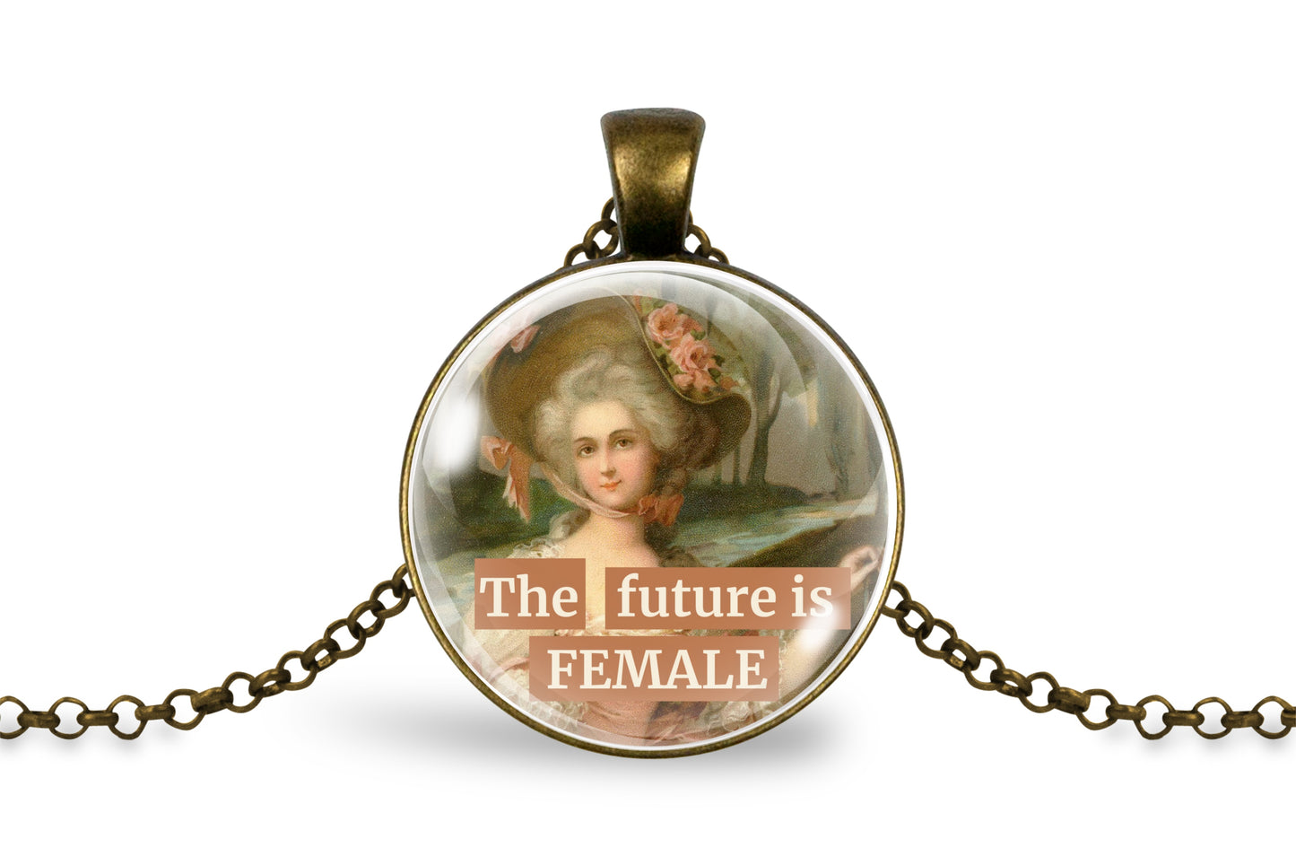 An antique bronze pendant necklace featuring a circular cabochon with a vintage portrait of a woman in a large hat and the text 'The future is FEMALE' in white lettering, displayed on a clean white background.