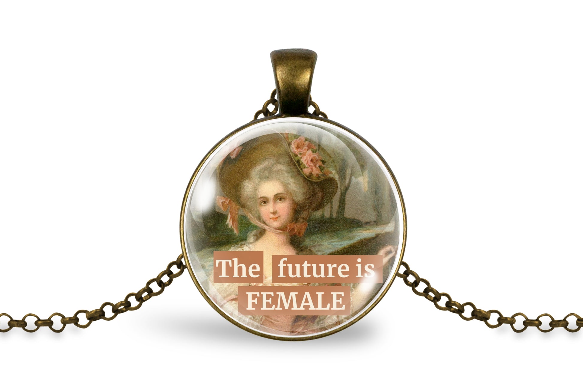 An antique bronze pendant necklace featuring a circular cabochon with a vintage portrait of a woman in a large hat and the text 'The future is FEMALE' in white lettering, displayed on a clean white background.