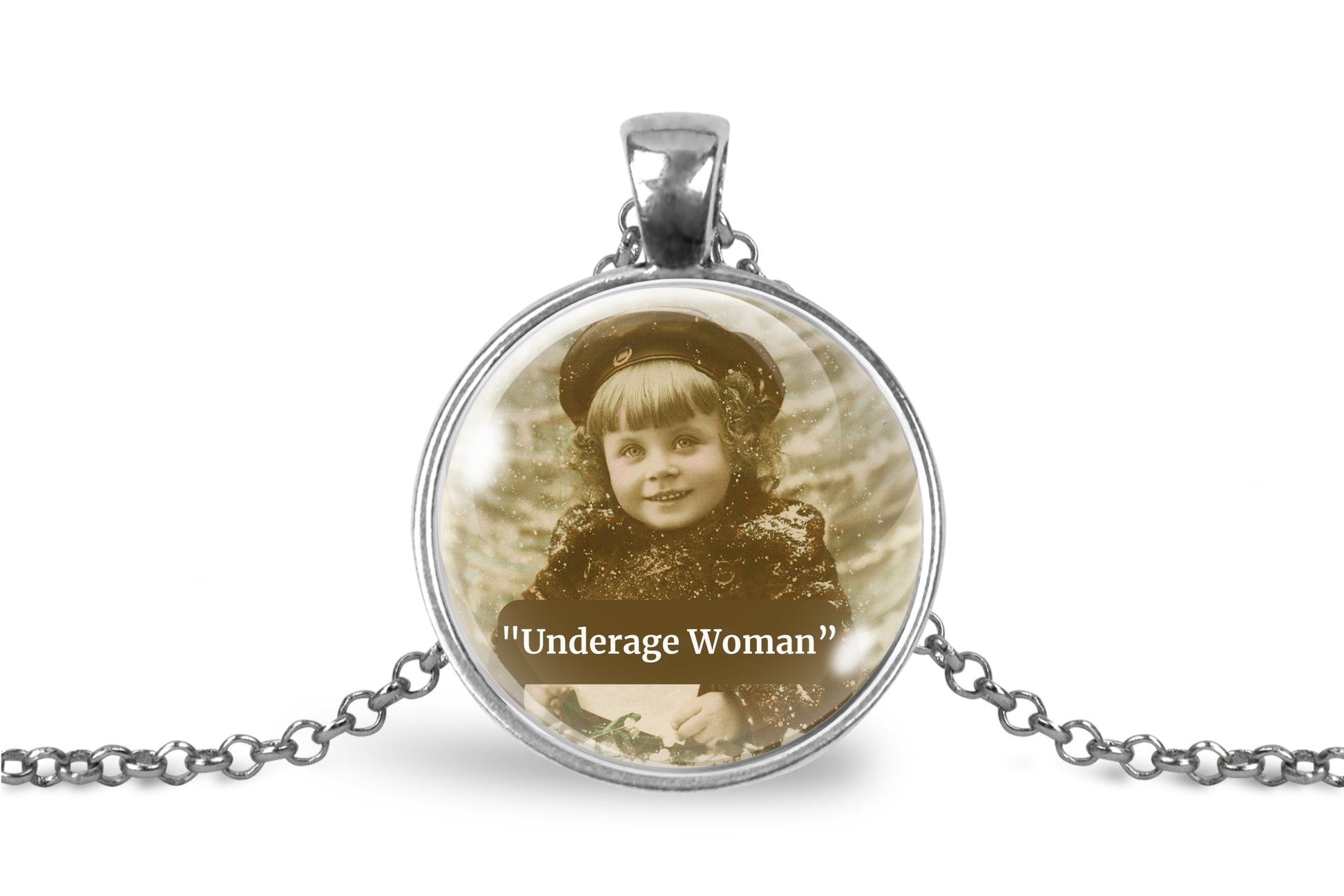 A silver pendant necklace featuring a circular glass cabochon with a sepia-toned vintage photograph of a young child and the text 'Underage Woman' printed below, shown on a white background with a silver chain.