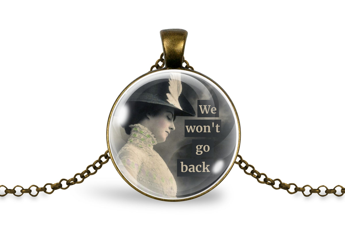 An antique bronze round pendant necklace featuring a vintage-style image of a woman in a hat with the text 'We won't go back' on a white background.