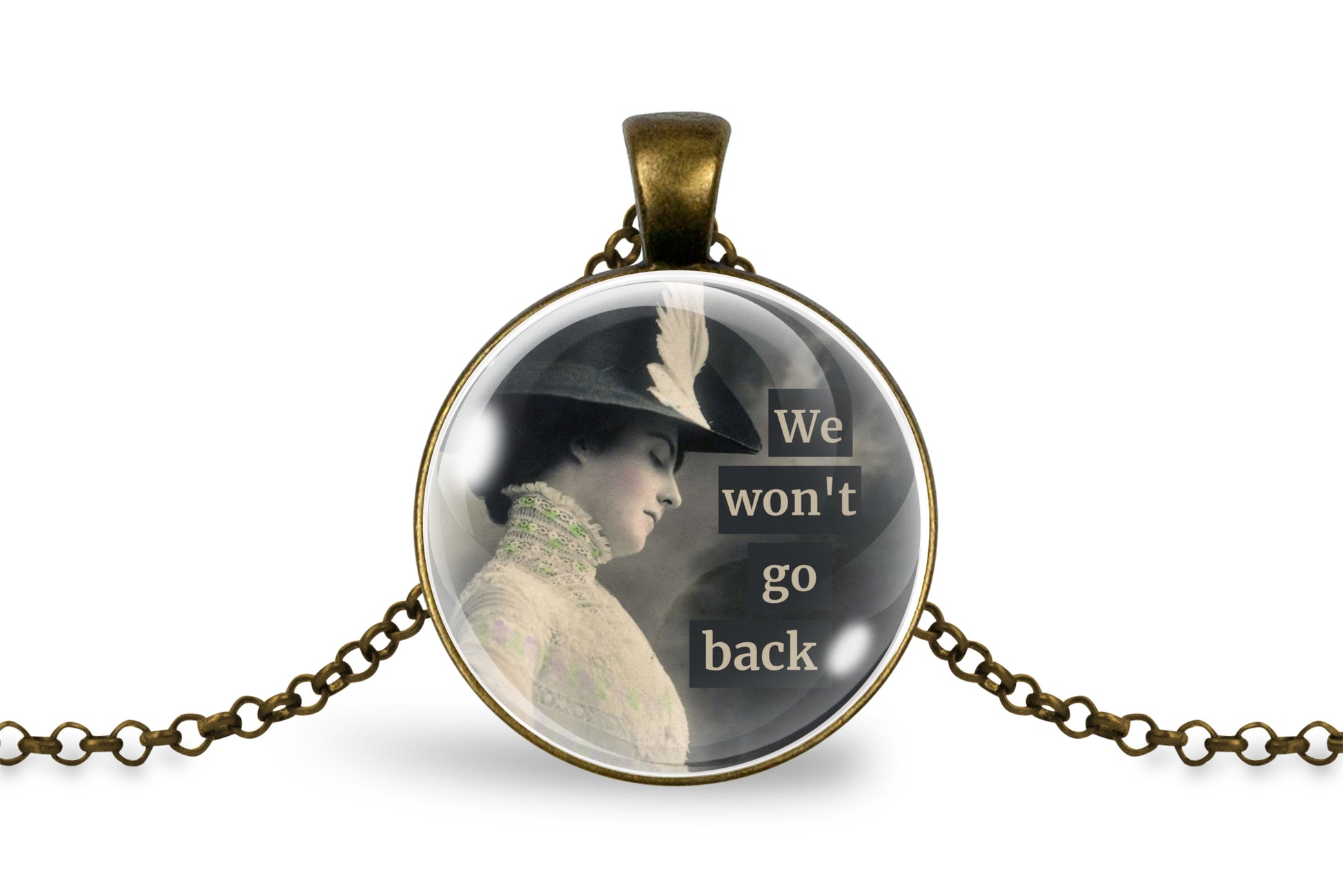 An antique bronze round pendant necklace featuring a vintage-style image of a woman in a hat with the text 'We won't go back' on a white background.
