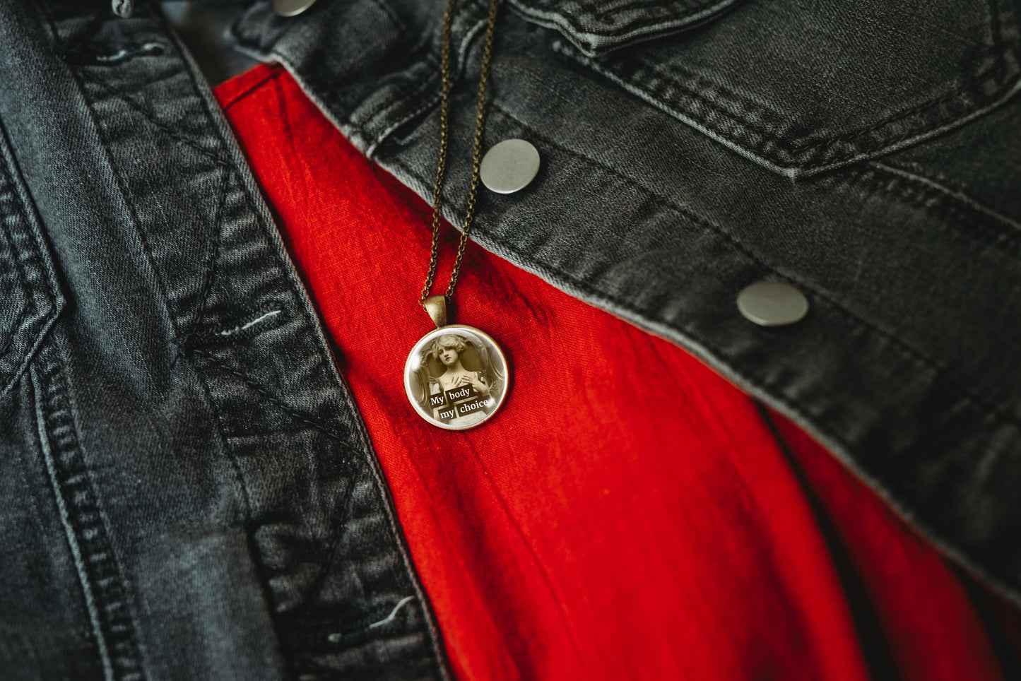 Product photo of a 1-inch glass cabochon pendant necklace featuring “My Body My Choice” with a sepia portrait of a vintage woman seated in an ornate chair on a 20-inch chain.