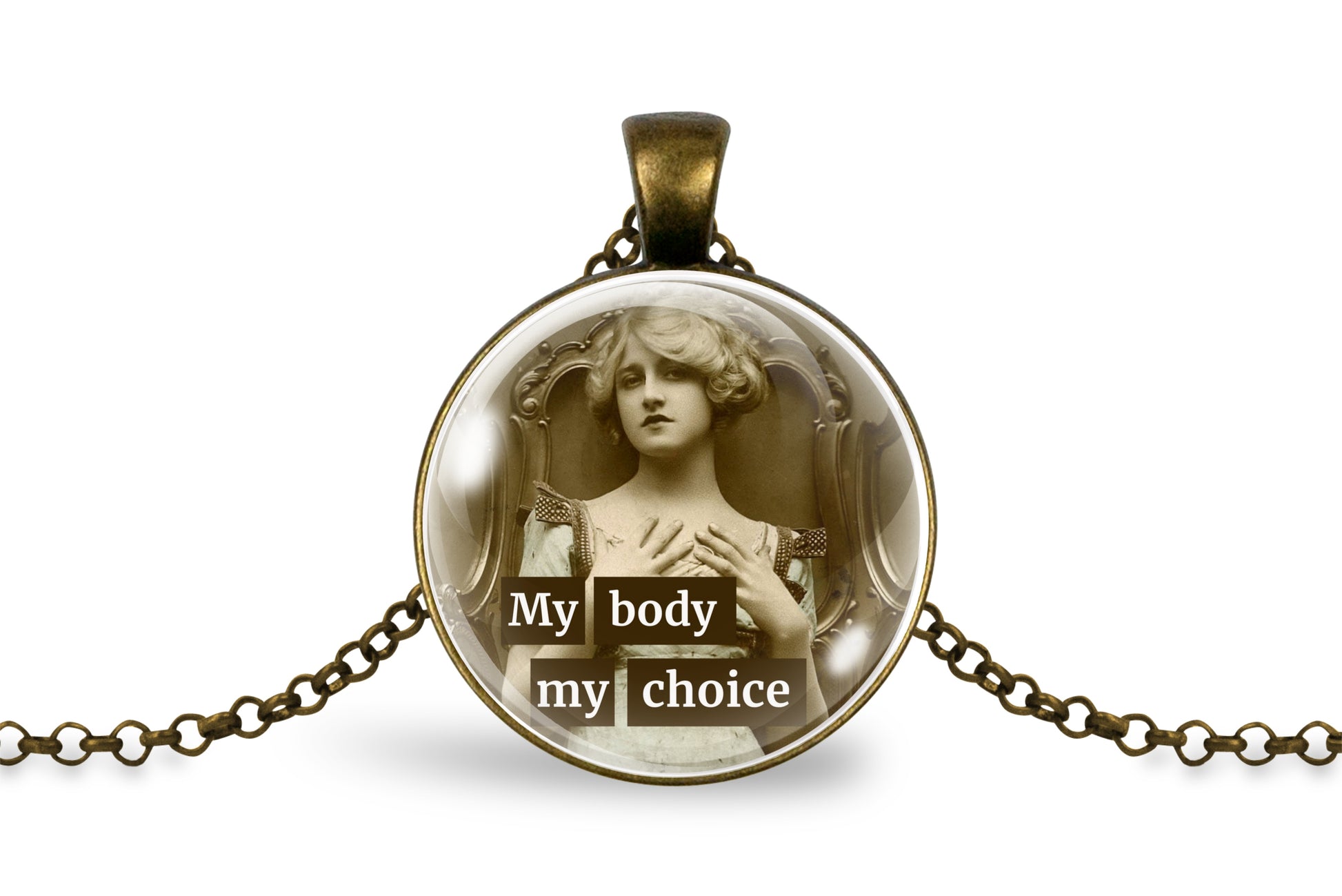 An antique-inspired bronze pendant necklace featuring a circular cabochon with a sepia-toned classical image of a woman and the text 'My body my choice' in white lettering, displayed on a clean white background.