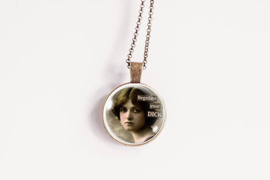Product photo of a 1-inch glass cabochon pendant necklace featuring “Regulate Your Dick” with a sepia portrait of a vintage-style woman on a 20-inch chain.