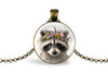 Close up image of a raccoon wearing a whimsical flower crown set in a bronze-plated bezel. 