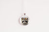 Close up image of a raccoon wearing a whimsical flower crown set in a silver-toned bezel. 