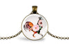 Necklace with a round pendant featuring a colorful rooster and floral design on a white background.