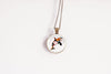 Necklace with a pendant featuring a whale design on a white background